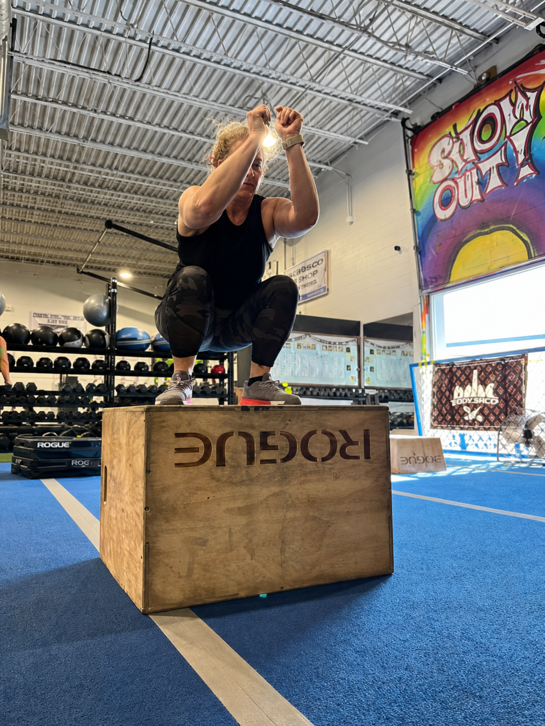 A Tedesco Body Shop athlete landing a box jump